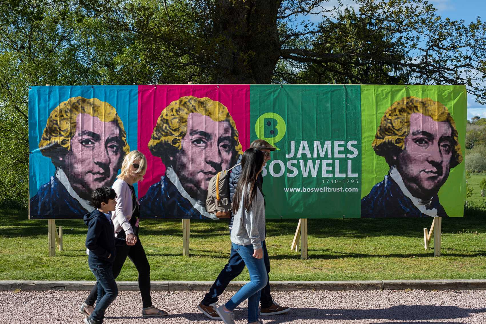 People walking in front of the Boswell Book Festival banner